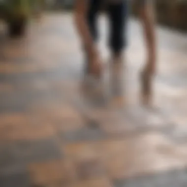 A DIY enthusiast installing deck tiles on a concrete patio.
